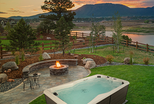 Backyard install of a swim spa with a firepit